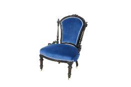 A Victorian carved ebonised framed, blue velvet upholstered, nursing chair.