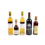 A group of five bottles of wine.