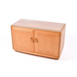 Ercol Windsor TV entertainment cabinet stand. Having two doors opening to reveal a glass shelf.