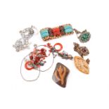 A small wooden jewellery box 'chest of drawers' and a few pieces of costume jewellery.