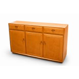 Ercol Windsor sideboard. Having three drawers over three panel doors.