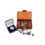 A small jewellery box with assorted costume jewellery and watches.