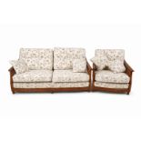 An Ercol bergere two piece suite. Consisting of a three seater sofa and an armchair.