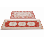 A 20th Century French Abusson style red ground rug along with a similar style runner,