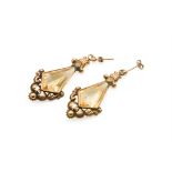 A pair of Victorian citrine and yellow metal drop earrings. The kite shaped faceted stones circa 2.