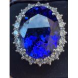 A certified 23.16 carat tanzanite & diamond oval cluster ring, the oval four-claw set mixed cut