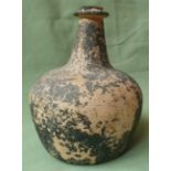 A 17thC glass onion shaped bottle, 7" high.