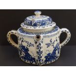 An early blue & white delft spouted pot & cover, 10" across handles - one handle restored.
