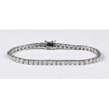 An 18 ct white gold and natural diamond tennis bracelet, diamonds 6.77 carats.