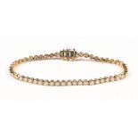 An 18 ct yellow gold tennis bracelet, set with natural diamonds weighing 2.13 carats.  Length 17.5
