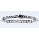 An 18 ct white gold and natural diamond tennis bracelet, diamond weight 14.43 carats.