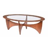 In the manner of G Plan a mid century oval glass topped coffee table, with cradle type support.