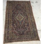 An Oriental rug, the central panel set with shaped medallion on a red,