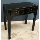 A Chinese black lacquered two drawer side table on square tapered legs to scroll feet,
