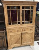 A 19th Century Irish pine cupboard, the moulded cornice with dentil frieze,