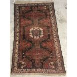 A Persian rug, the central panel set with central medallion on a white ground,