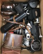 A box of various photographic equipment including a Yashica TL-Electro camera,