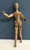 A circa 1900 carved treenware artist's lay figure with jointed body and well carved features,