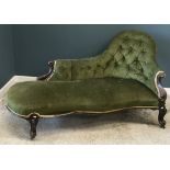 A late Victorian upholstered spoon back buttoned upholstered chaise lounge with carved mahogany