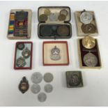 A collection of various medals and medallions to include a Victoria South Africa medal,