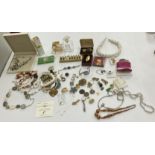 A box containing a quantity of various costume jewellery including necklaces, bracelets etc,