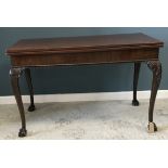 A 19th Century mahogany fold-over dining table, the plain top over a plain frieze,