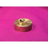 A Cartier 9 carat gold pill box with reeded decoration and D shaped handle to the cover (bears