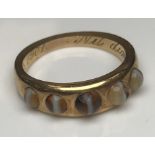 A yellow metal mounted agate five stone dress ring inscribed to interior “Nil dimidium est December