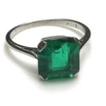 A platinum set square cut emerald solitaire ring, 2.