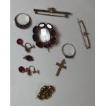 A collection of unmarked yellow metal jewellery including a garnet brooch with central vacant panel,