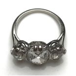 A platinum mounted three stone diamond ring, the central oval stone approx.