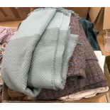 A collection of assorted household textiles to include tablecloths, bed throws,