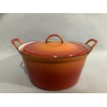 A large Le Creuset two-handled pan with lid, 35.5cm over handles x 14cm high, with wear to the