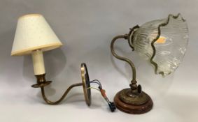 A cast gilt metal wall light with scroll arm and moulded glass shade together with a cast gilt metal