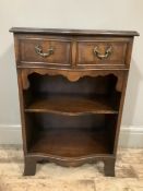 A mahogany crossbanded cabinet of serpentine outline fitted with two drawers with swing handles