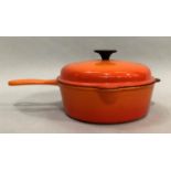 A Le Creuset lidded pan with double pouring lip and slotted handle, 22.5cm diameter x 7cm high