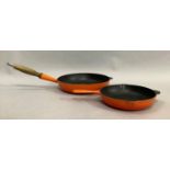 A Le Creuset frying pan, 28cm diameter, together with a smaller frying pan with pouring lips, 23cm