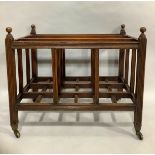 A 19th century mahogany Canterbury with three divisions, reeded square section frame with turned