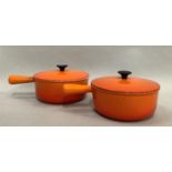 A pair of Le Creuset lidded pans each with solid single handle, 22.5cm diameter, one lid handle