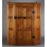 THOMPSON OF KILBURN 'MOUSEMAN' an English oak hanging corner cupboard, the single door having six