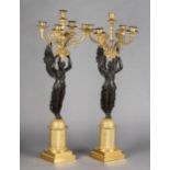 A PAIR OF 19TH CENTURY FRENCH EMPIRE PATINATED AND GILDED BRONZE FIVE-LIGHT CANDELABRA