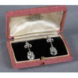 A PAIR OF DIAMOND PENDANT EARRINGS in 18ct white gold, early 20th century, each claw set with a