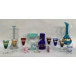 A set of six harlequin coloured and gilt wine glasses, 13cm high, a blue glass carafe and tumbler
