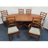 ERCOL ELM AND BEECH DINING ROOM TABLE in the 'Golden Dawn' style, together with eight accompanying