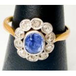 An 18ct gold sapphire and diamond ring, centrally set with an oval-shaped sapphire, surrounded by 10