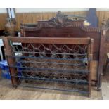 An Edwardian walnut double bedstead, with curved top rail and square vertical spindles, with side