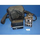 A vintage German Agfa black box camera and a 20th c. Polaroid camera with carrying case.