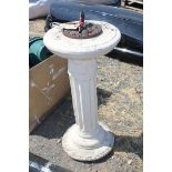 A metal sundial on a concrete plinth, 15" diameter x 31" high.
