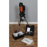 A Celestron NexStar 4se Starbright XLT telescope on tripod along with a Celestron Observer's