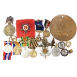 Collection of various military campaign medals and badges, to include a WWI Memorial Plaque